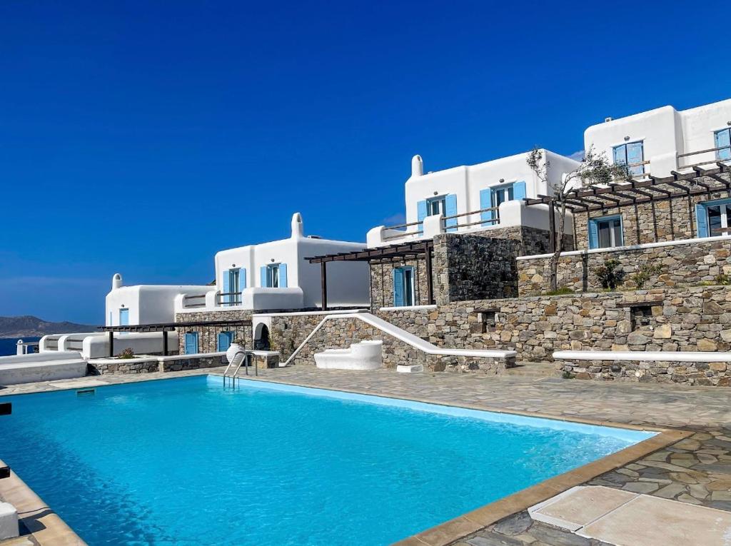 a swimming pool in front of a villa at Mykonos Dot - The Villas in Mikonos