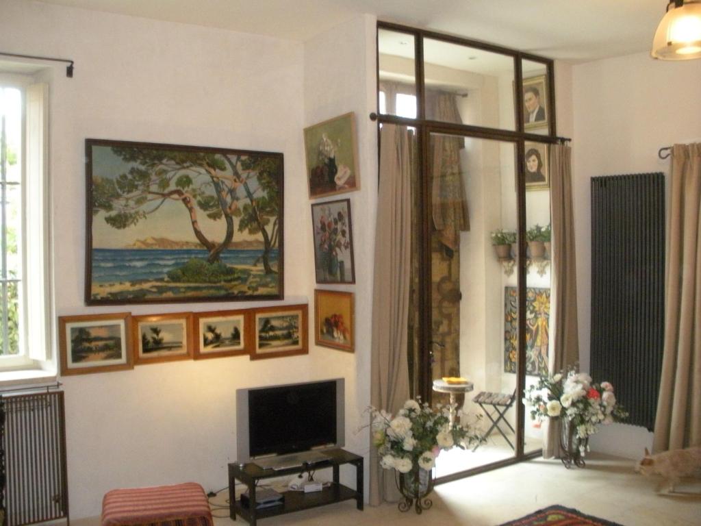 
a living room with a painting on the wall at Le Couvent du Vieux Port in Marseille
