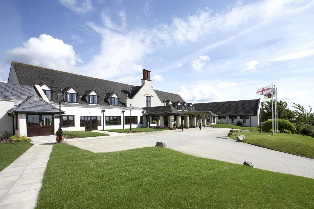 a large white building with a large driveway at Lancaster House Hotel in Lancaster