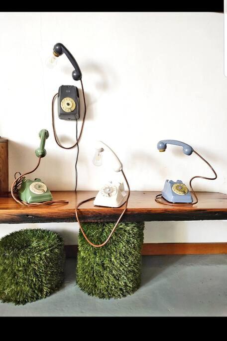a table with two lights and a telephone on it at L'Artista in Trecastagni