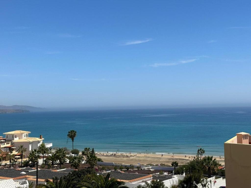 a view of the beach and the ocean from a building at Casa Sara in Costa Calma