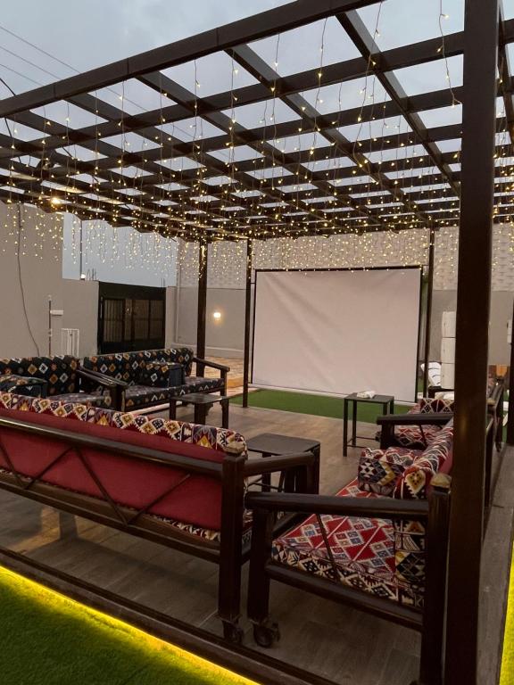 a room with a projection screen and several beds at شاليه الجوهرة الدرب in Ad Darb