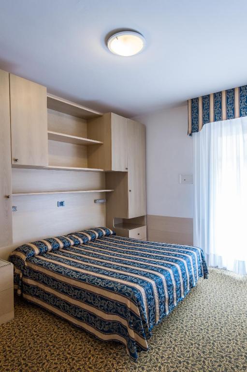 Postel nebo postele na pokoji v ubytování Hotel Christian