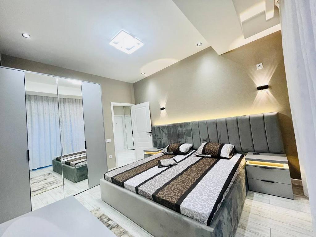a bedroom with a large bed in a room at Narimanova Residence in Baku
