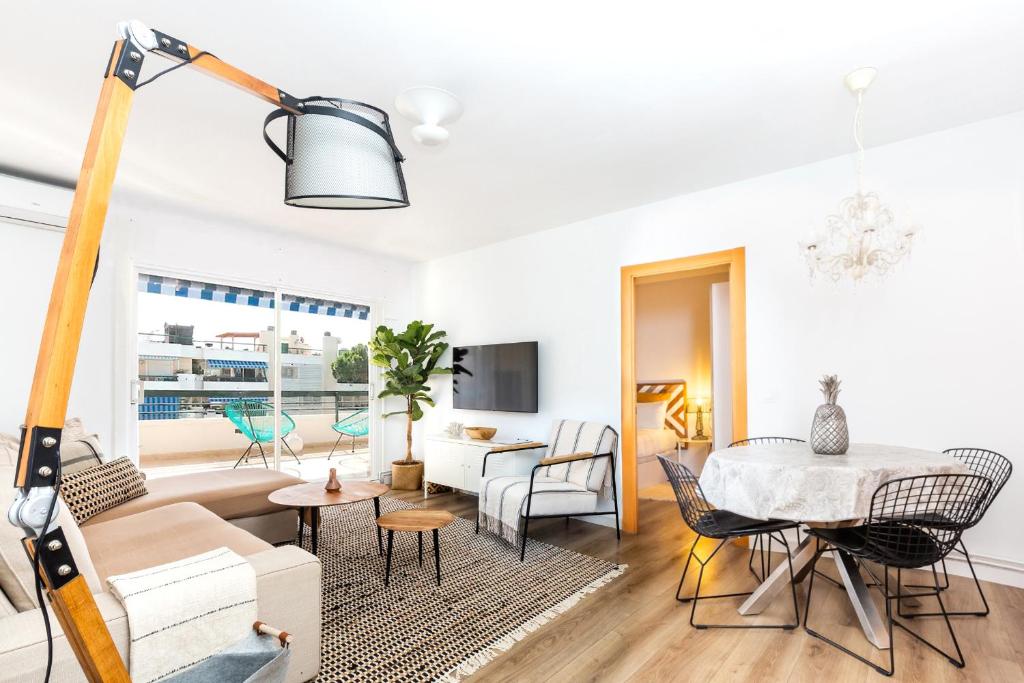 a living room with a table and chairs and a dining room at Casa Natura Gava Beach in Barcelona