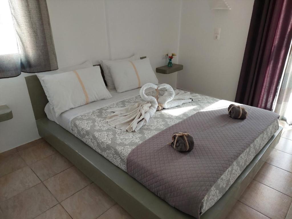 a bedroom with a bed with towels on it at Marousi Rooms in Perissa