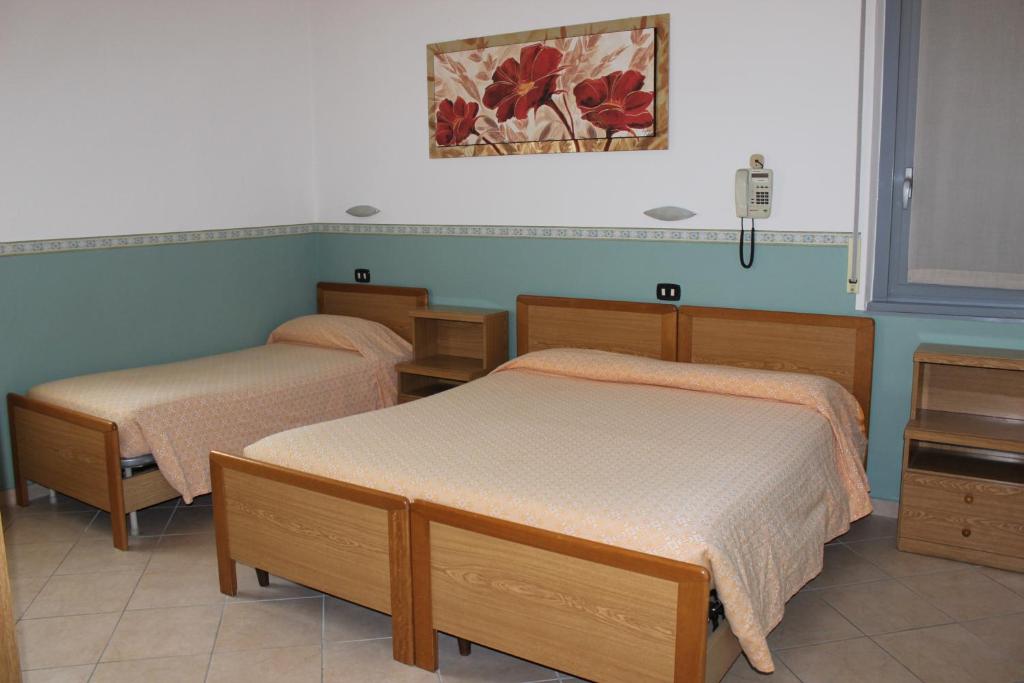 Postel nebo postele na pokoji v ubytování Hotel Milano