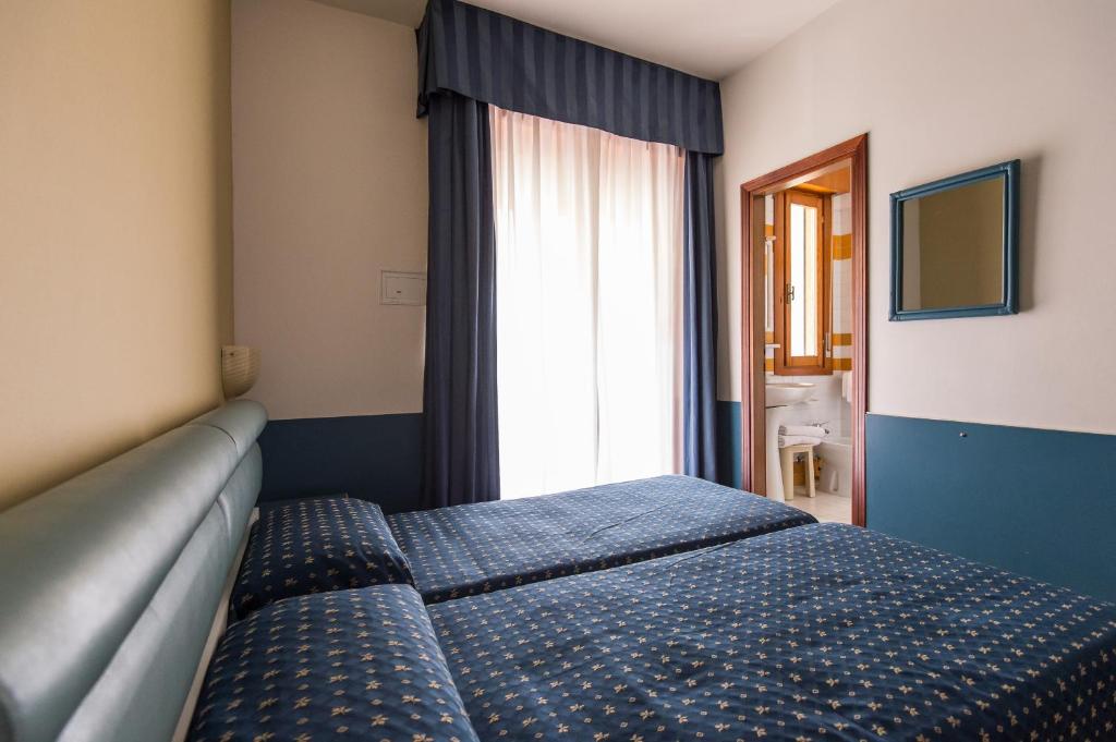 Postel nebo postele na pokoji v ubytování Hotel Christian