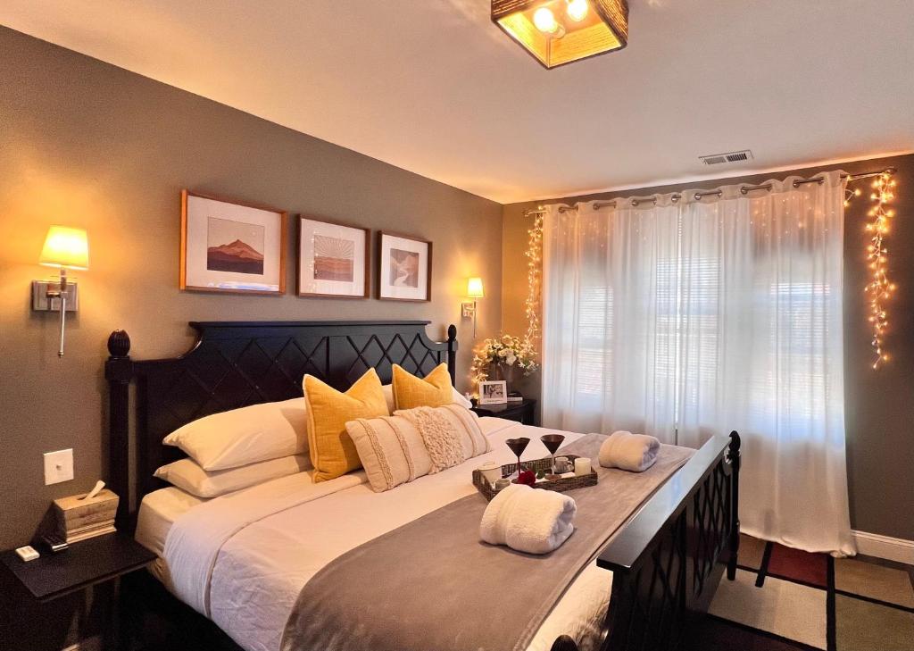 a bedroom with a large bed with yellow pillows at Modern/Luxury 2 bdrm- KING Bed- University City in Philadelphia