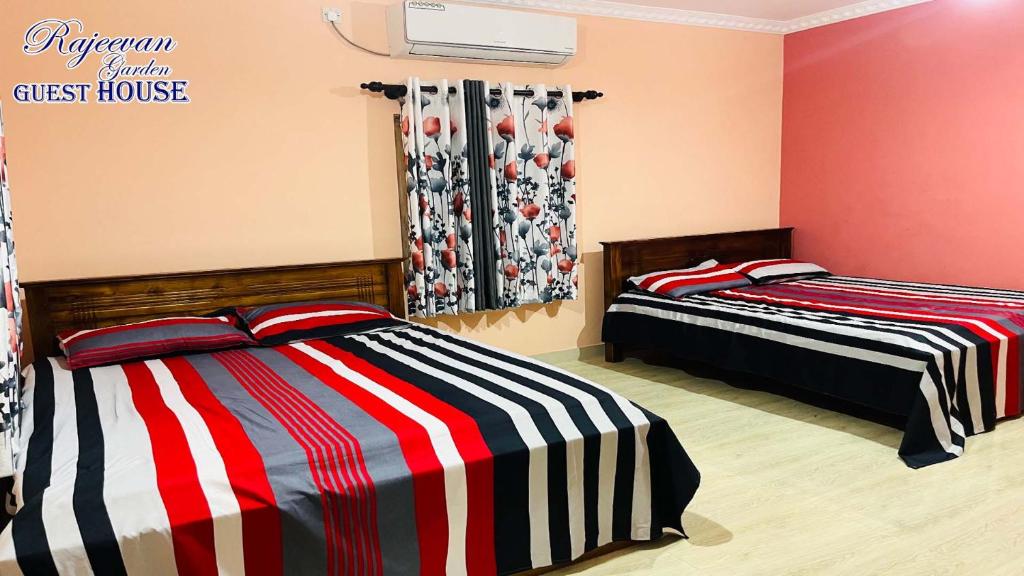 Postel nebo postele na pokoji v ubytování Rajeevan Garden Guest House