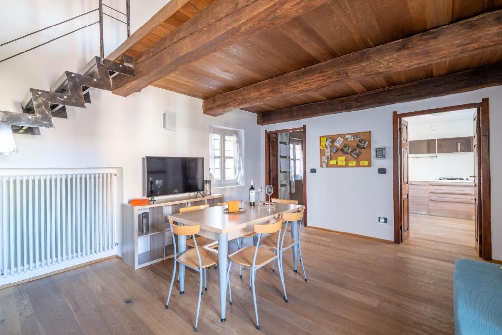 a kitchen with a table and chairs in a room at La finestra sulle Langhe - m3langhe in Cherasco