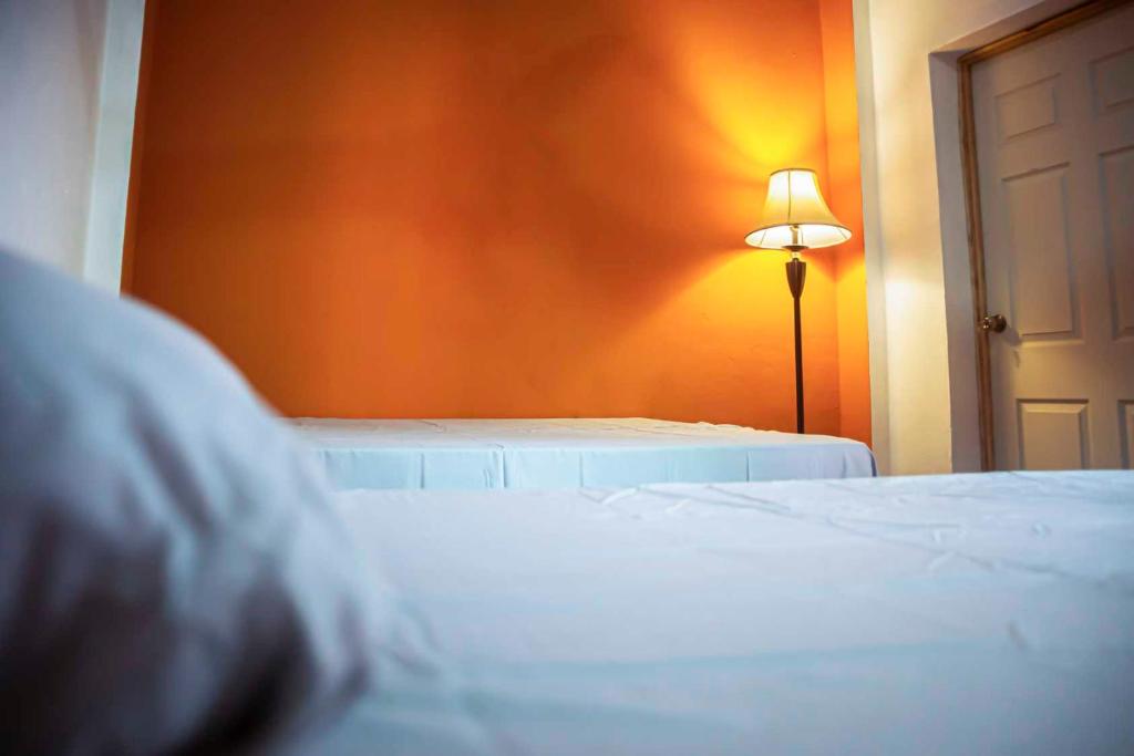 a bedroom with a white bed and a lamp at Alojamientos Santa Marta La Unión in La Unión