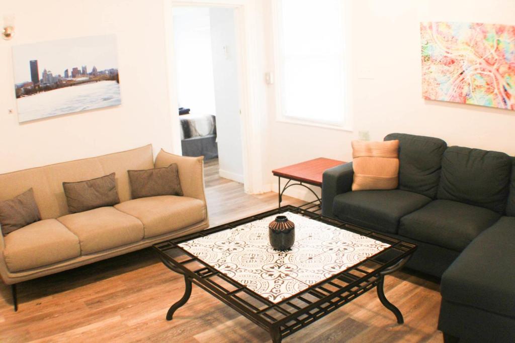 a living room with two couches and a coffee table at 2BR - Parking - 5 Min to North Shore! in Pittsburgh