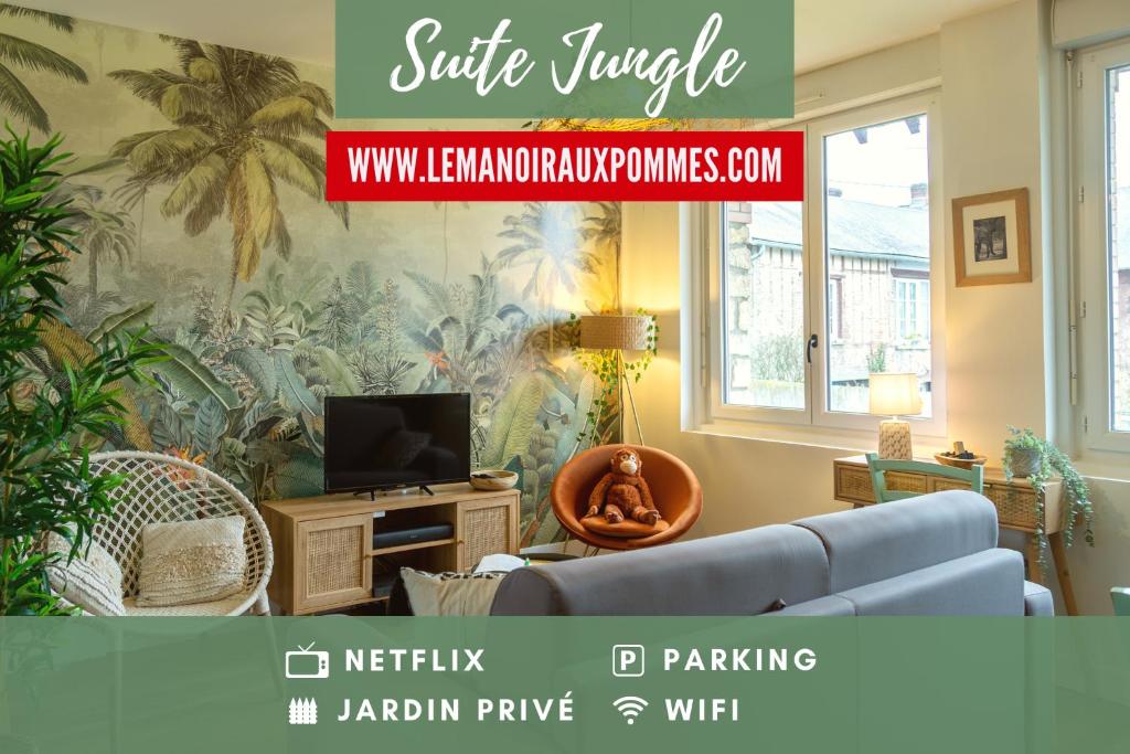 a living room with a blue couch and a tv at SUITE JUNGLE - JARDIN, NETFLIX et PARKING - Le Manoir aux Pommes in Orbec-en-Auge