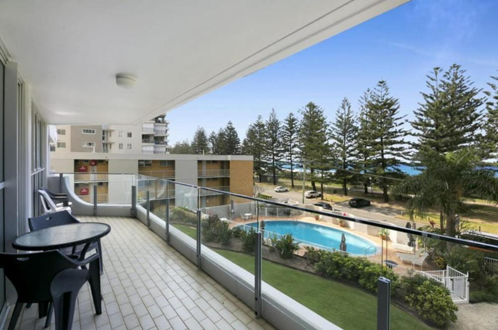 a balcony with a view of a swimming pool at Cashelmara Burleigh - Hosted by Burleigh Letting in Gold Coast