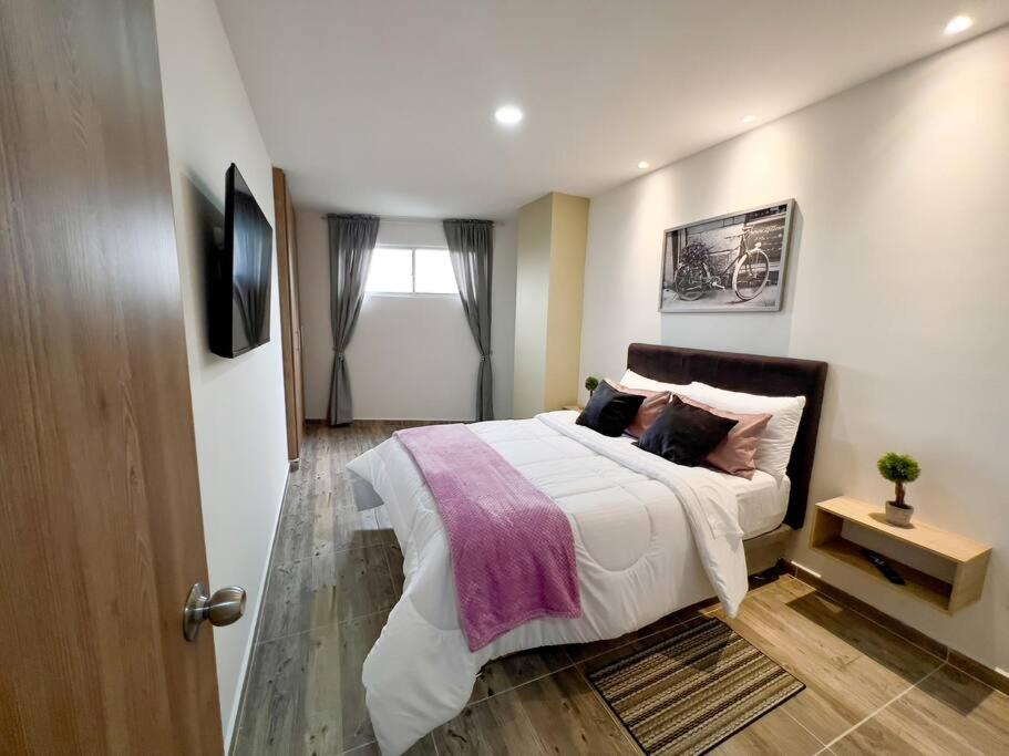 Llit o llits en una habitació de 202S Encantador apartamento para ti!