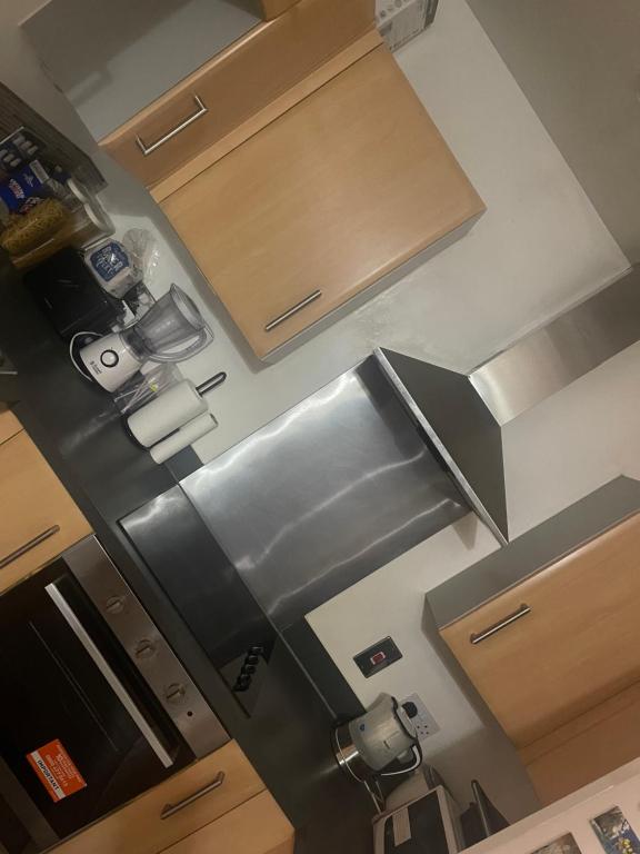 an overhead view of a kitchen with stainless steel appliances at Homely abode in Croydon