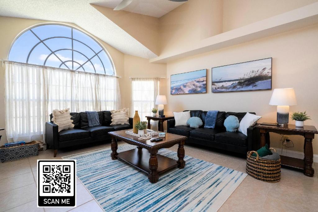 a living room with a couch and a table at Beautiful cozy Retreat near Disney - spacious condo in Kissimmee