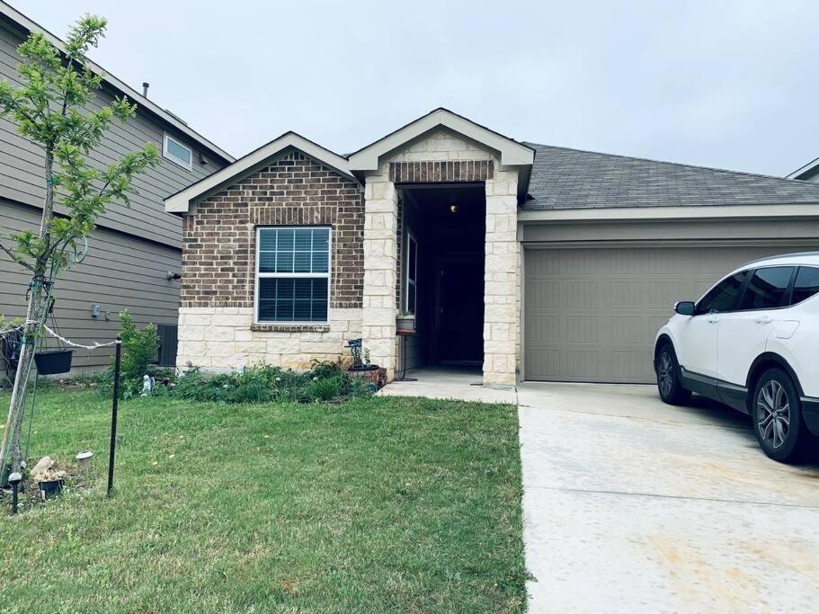 a white car parked in front of a house at Cheerful three-bedroom home in San Antonio