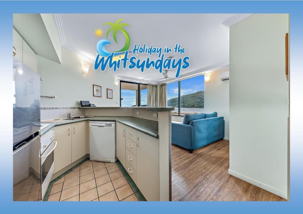 a kitchen with a sign that reads holiday up the whiskers at Marina views at Airlie 10F - 1 bedroom in Airlie Beach