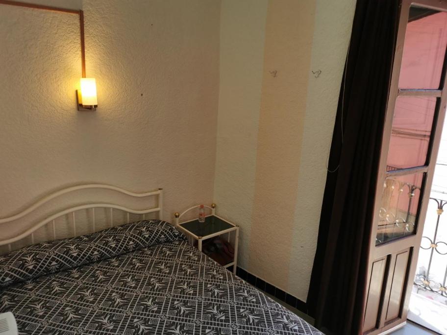 Postel nebo postele na pokoji v ubytování HOTEL LIMÓN
