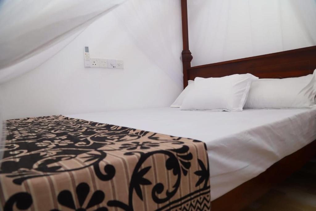 Postel nebo postele na pokoji v ubytování Isira Guest