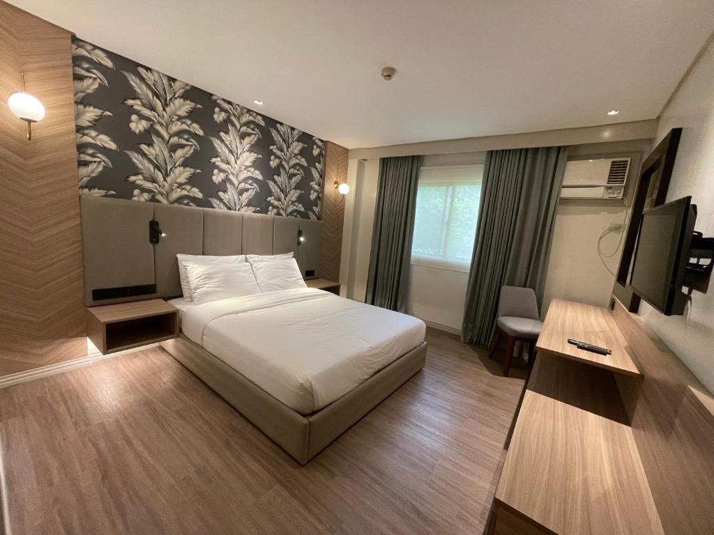 Postel nebo postele na pokoji v ubytování Luisita Central Park Hotel