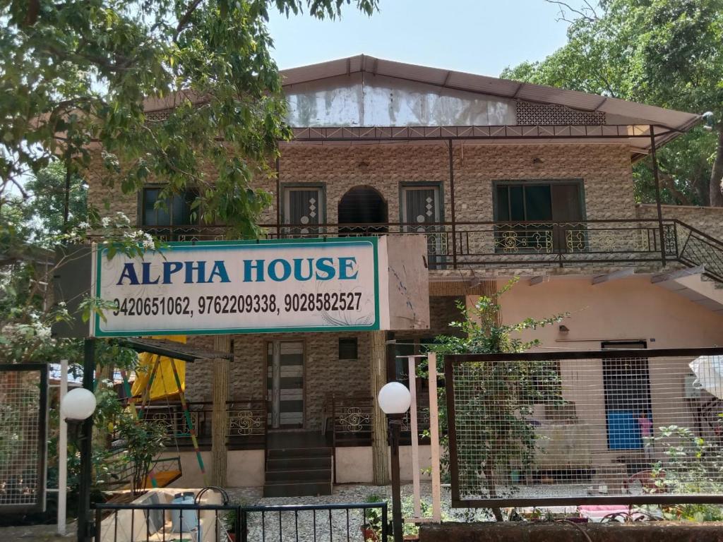 a building with a sign that reads alpha house at Alpha House Matheran in Matheran