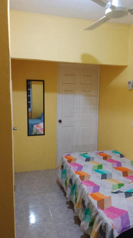 Postel nebo postele na pokoji v ubytování El Rincón del Ángel Tuxpan