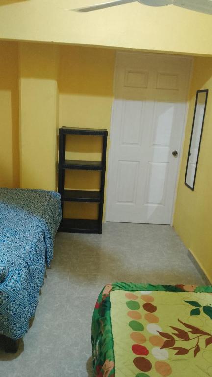 Postel nebo postele na pokoji v ubytování El Rincón del Ángel Tuxpan