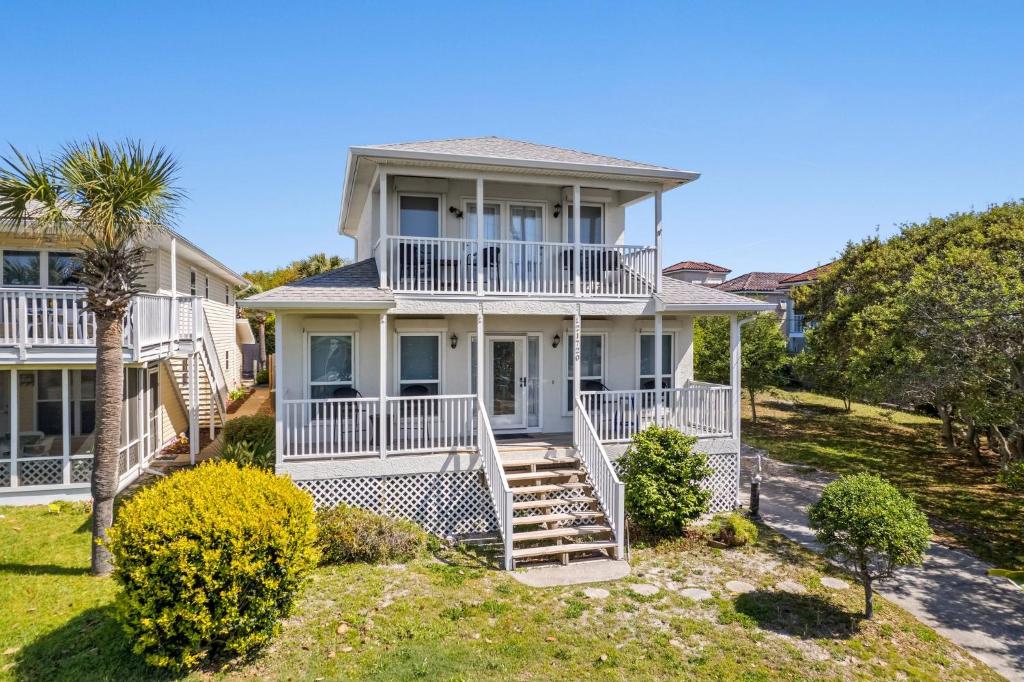 a large white house with a porch and stairs at 21720 Front Beach Rd - Pelican's Nest in Panama City