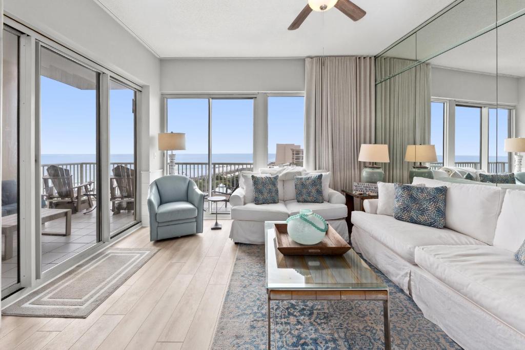 a living room with a couch and a table at Crescent at Miramar 406 - Sheer Bliss in Destin