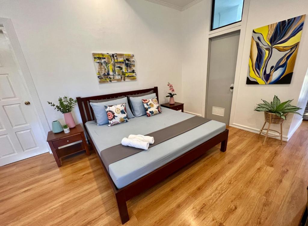 a bedroom with a large bed in a room at Big & Homey in exclusive village in Davao City