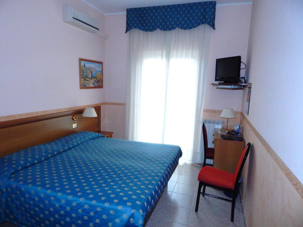 En eller flere senge i et værelse på Hotel Torre Antica