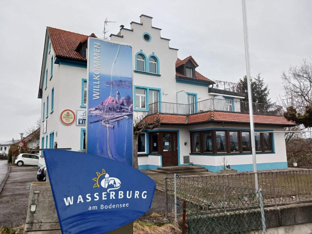 a house with a sign in front of it at Gasthaus Wilhelmshöhe in Wasserburg am Bodensee