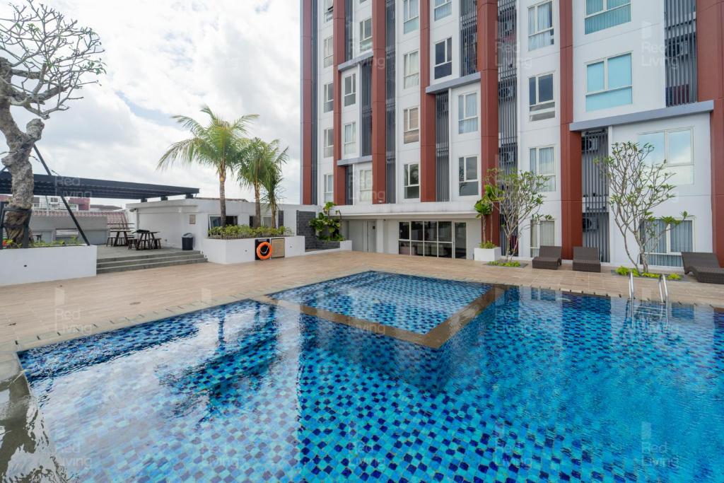 a swimming pool in the middle of a building at RedLiving Apartemen Barsa City by Ciputra - WM Property in Yogyakarta
