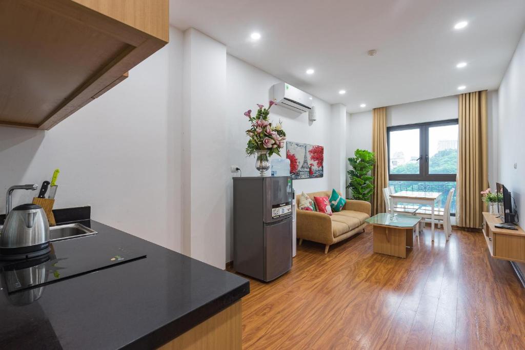 a kitchen and living room with a counter top at Granda Quan Hoa Apartment in Hanoi