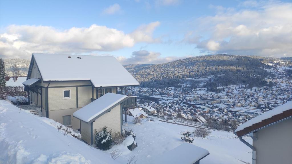 a building on top of a snow covered mountain at Duplex Estelle - 2 couples ou famille in Gérardmer