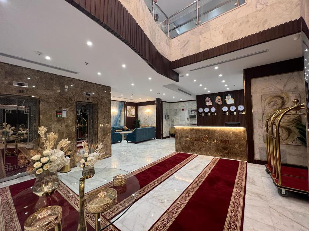 a large room with a large red rug in a building at فندق بياك أوتيل الروضة in Mecca