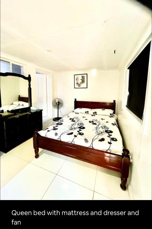 a bedroom with a bed with mattress and cheese and fan at Private entry studio room with bathroom and kitchen in Pendle Hills