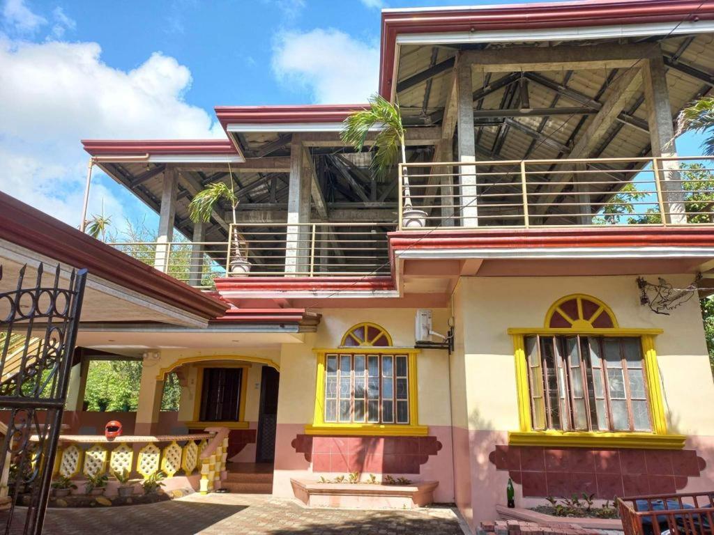 a large house with a balcony on top of it at CABRERA GUEST HOUSE exGREEN BAMBOO GUIMARAS in Nueva Valencia