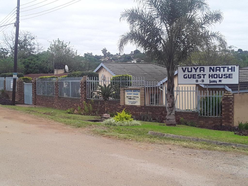 una señal para una casa de huéspedes junto a una valla en Vuya Nathi Bed and Breakfast, en Manzini
