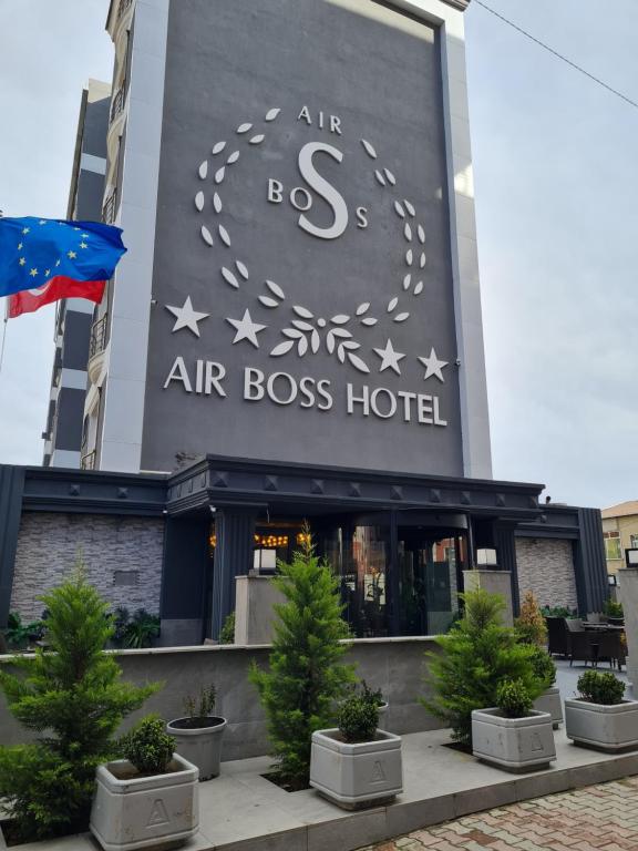 an air boss hotel with trees in front of it at Air Boss Istanbul Airport and Fair Hotel in Istanbul