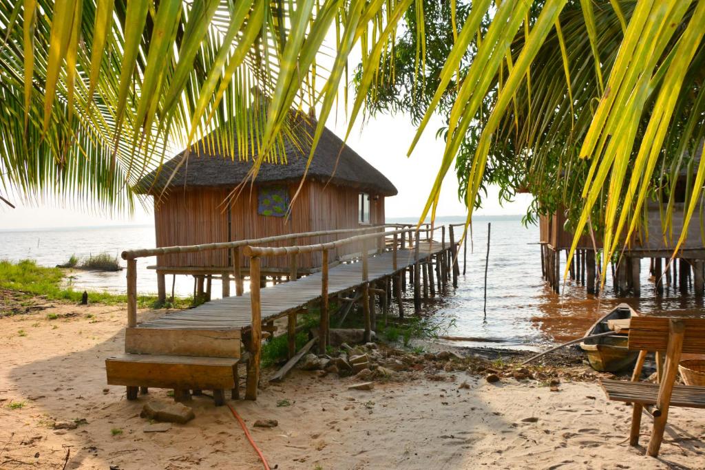 a house on a dock in the water at Bel Ami in Ouidah