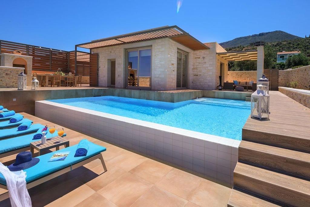 a swimming pool in the backyard of a house at Deluxe Crete Villa Villa Rhea 3 Bedroom Private Pool Sea View Chania in Kambiá