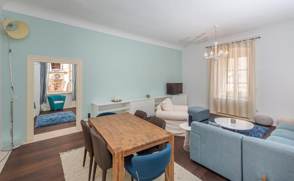 un soggiorno con un divano blu e un tavolo di Apartment Gospar a Dubrovnik