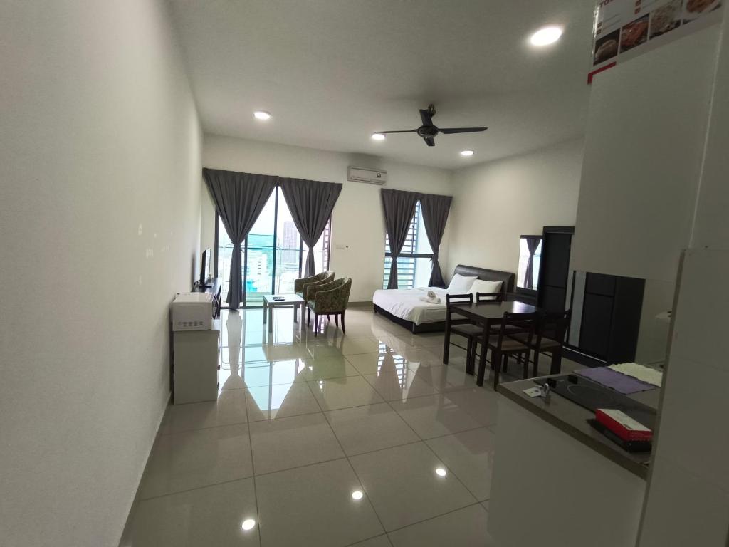 a living room with a bed and a dining room at Peace home 23 in Cyberjaya