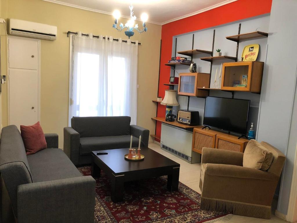 a living room with two couches and a tv at Olive - HappyHostGr - Downtown Apartment in Volos