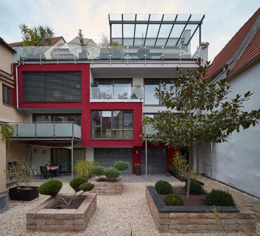 a red house with a courtyard in front of it at Apartment Magnolia in Karlstadt