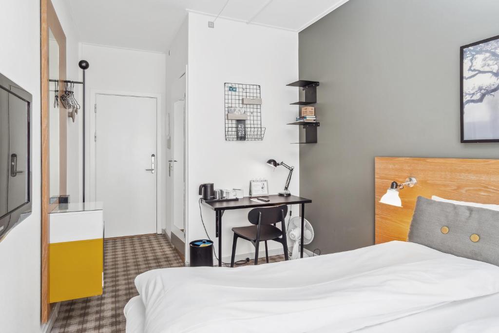 Postel nebo postele na pokoji v ubytování Ibsens Hotel